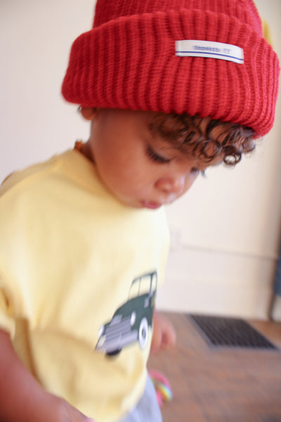 Toddler girl wearing red beanie and yellow t-shirt with green chevy truck graphic 