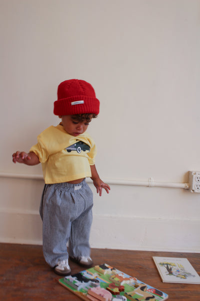Small girl wearing yellow t-shirt with truck graphic 