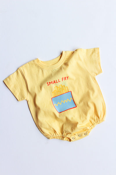 Yellow baby romper with 'Small Fry' and french fry graphic on a light gray background