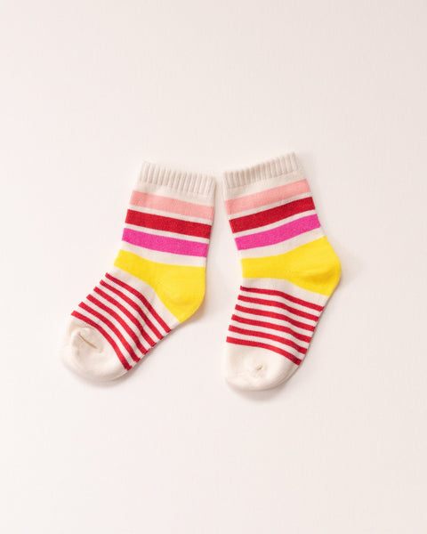 Pair of colorful striped socks on a light pink background