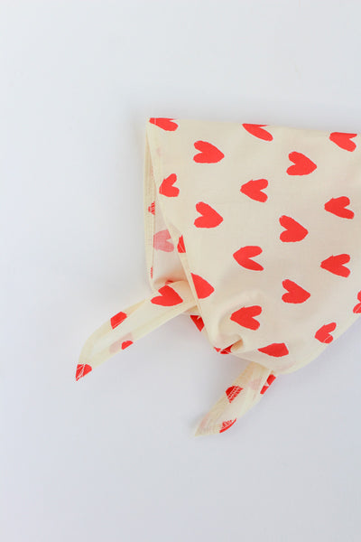 off white bandana with red heart pattern on a white background