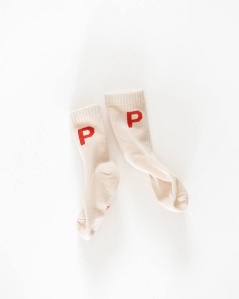 A pair of white crew socks with the letter 'P' printed in red on each foot
