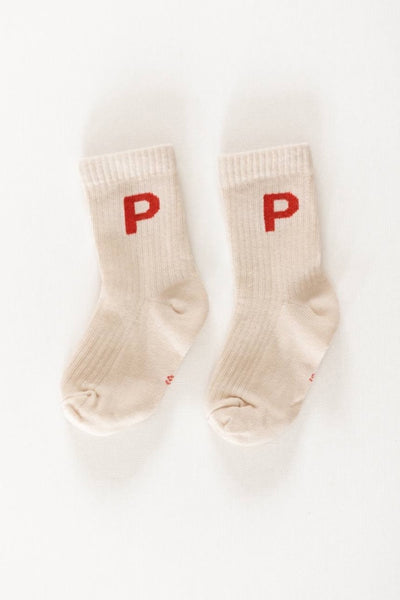 A pair of white crew socks with the letter 'P' printed in red on each foot