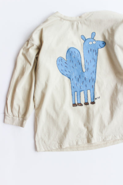 Beige long sleeve with a blue cartoon camel design on a white background