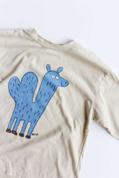 Beige t-shirt with a blue cartoon Camel design on a white background