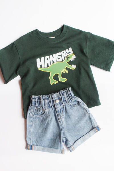 Green t-shirt with 'Hangry' dinosaur graphic and denim shorts on a white background