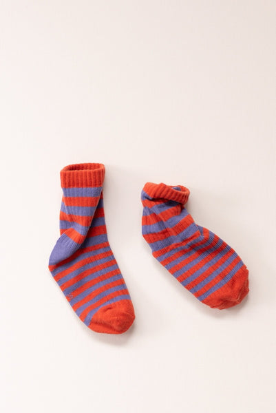 Pair of red and purple striped socks on a white background