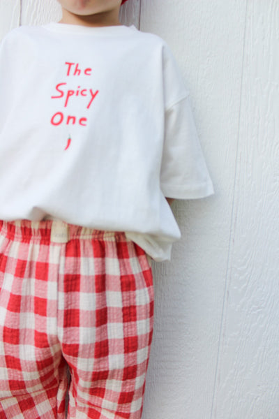 kid against white wall wearing the spicy one t-shirt 