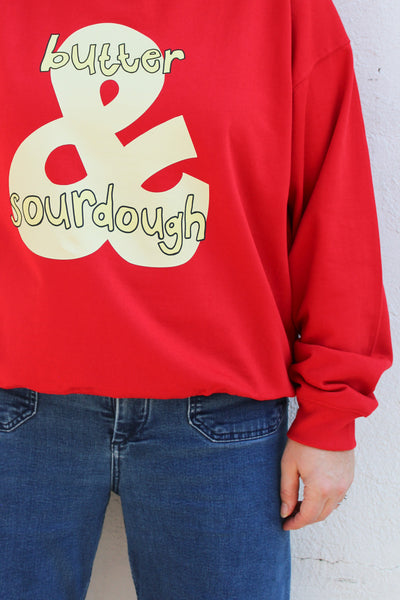 Women’s red cotton sweatshirt with a hand-drawn sourdough and butter graphic
