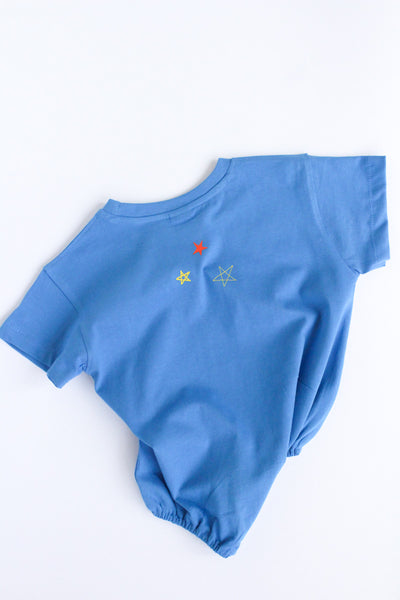Back of Blue baby romper with embroidered stars on a white background