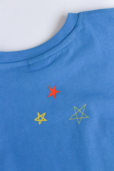 Blue baby romper with red, yellow, and green star designs on a white background