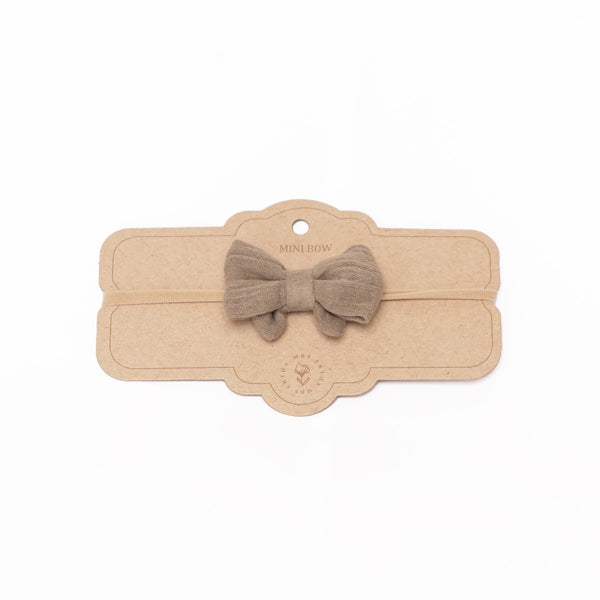 a headband with a brown bow 