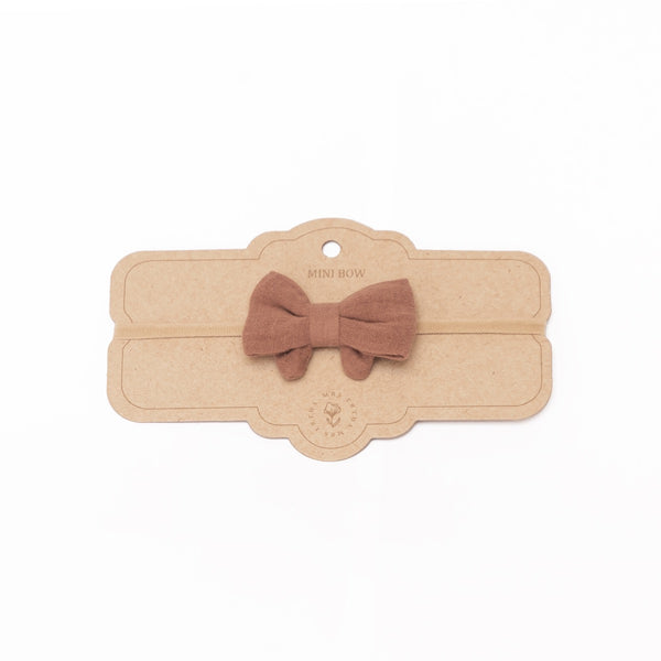 a pink bow headband for a baby