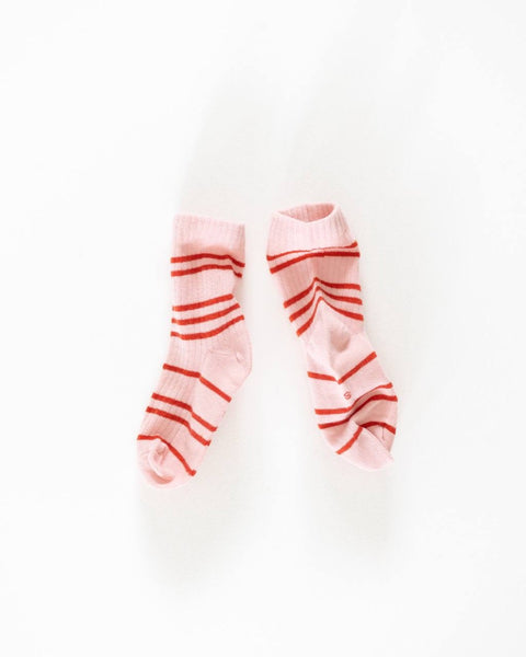 A pair of pink socks with red stripes, displayed against a white background.