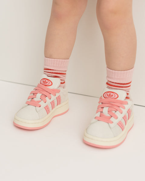 A pair of pink socks with red stripes, displayed against a white background.