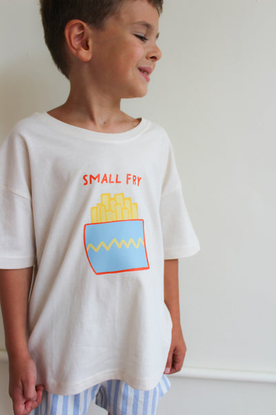 Child wearing a white t-shirt with 'Small Fry' graphic design on a plain background