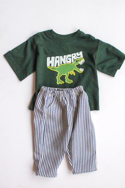 Children's outfit with green t-shirt and striped pants on a white background