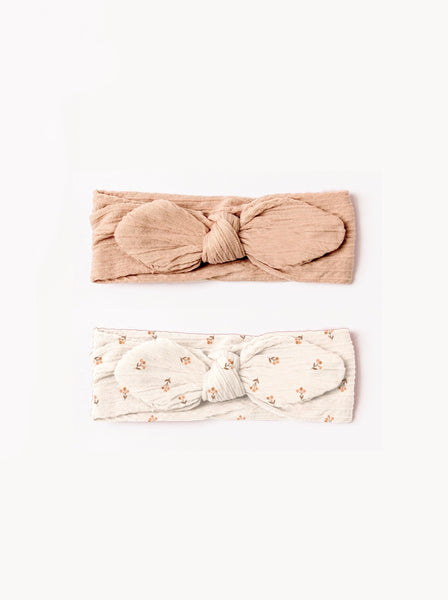 pink bow headbands and a beige headband for babies 
