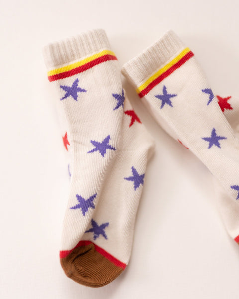 White socks with star patterns and colorful accents on a light background