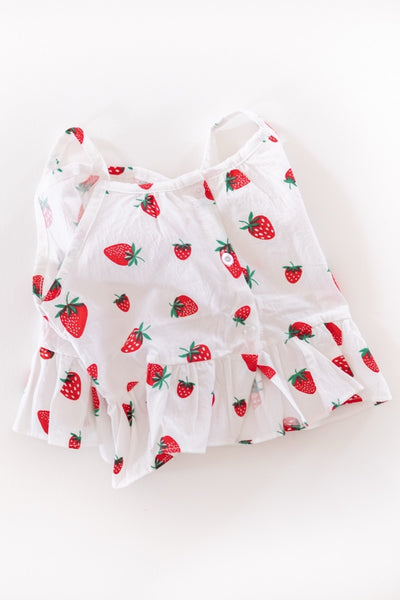 White blouse with red strawberry pattern on a white background