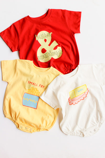 3 baby rompers in white, red, and yellow 
