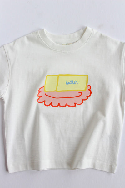 White t-shirt with a butter dish graphic design on a white background