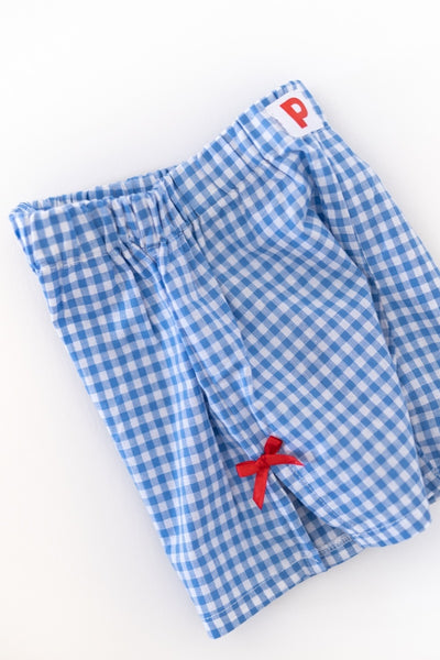 Blue and white checkered gingham woman shorts with a red bow. 